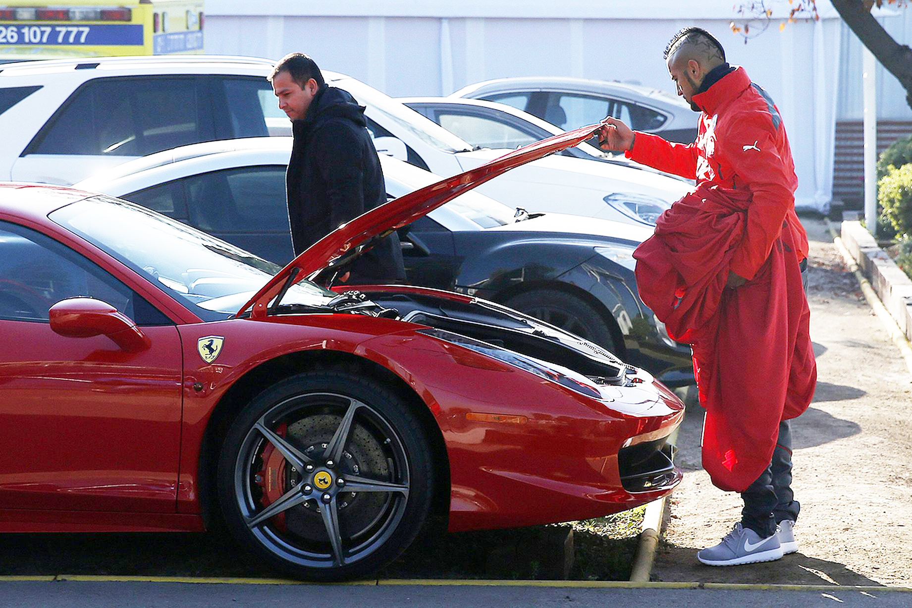 EPA_ONE-USE-ONLY-Arturo-Vidal-R-opens-the-trunk-of-his-Ferrari