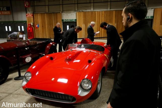 Visitors look at a red 1957 Ferrari 335 Sport Scaglietti model on display at the Paris Retromobile fair in Paris, France, February 5, 2016. REUTERS/Philippe Wojazer