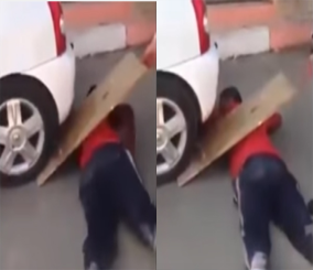 "فيديو" شاهد شاب يسمح لسيارة بالمرور فوقه في تحد خطير 3